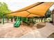 Well-maintained community playground with a shade canopy, green slides, and play structures for outdoor activities at 3022 E Santa Fe Ln, Gilbert, AZ 85297
