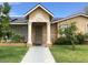 Inviting front porch with classic columns and detailed archway, with a well-kept lawn and mature plants at 3116 W Dailey St, Phoenix, AZ 85053