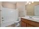 Bright bathroom featuring a shower, toilet, wood vanity, and large mirror at 3434 E Baseline Rd # 126, Phoenix, AZ 85042