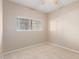 Neutral bedroom with light carpet, a window, and a ceiling fan at 3434 E Baseline Rd # 126, Phoenix, AZ 85042