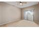 Bedroom with a sliding glass door and a ceiling fan, featuring neutral paint at 3434 E Baseline Rd # 126, Phoenix, AZ 85042