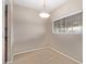 An empty dining room features a hanging light fixture, neutral paint, and a large window at 3434 E Baseline Rd # 126, Phoenix, AZ 85042