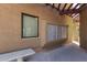 Exterior view of condo mailboxes, window with blinds, bench, and overhead beams at 3434 E Baseline Rd # 126, Phoenix, AZ 85042