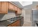 This well-lit kitchen features stainless steel appliances, wooden cabinets, and tile floors at 3434 E Baseline Rd # 126, Phoenix, AZ 85042