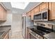 Galley kitchen with stainless steel appliances and stone countertops at 3434 E Baseline Rd # 126, Phoenix, AZ 85042