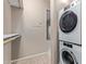 A stacked washer and dryer inside a cozy laundry area with ample storage and a neutral color palette at 3434 E Baseline Rd # 126, Phoenix, AZ 85042