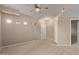 Spacious living room with neutral carpet, ceiling fan, and natural lighting at 3434 E Baseline Rd # 126, Phoenix, AZ 85042