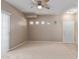 Spacious living room with neutral carpet, ceiling fan, and natural lighting at 3434 E Baseline Rd # 126, Phoenix, AZ 85042