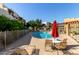 Community pool area with comfortable lounge chairs, tables and mature trees at 3434 E Baseline Rd # 126, Phoenix, AZ 85042