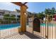 View of the community pool behind a security gate showing pool rules and spa policies for resident access at 3434 E Baseline Rd # 126, Phoenix, AZ 85042