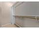A well-organized walk-in closet has built-in wooden shelves and carpet floors at 3434 E Baseline Rd # 126, Phoenix, AZ 85042