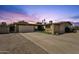 Charming single-level home with a spacious driveway and desert landscaping at twilight at 3537 W Shangri La Rd, Phoenix, AZ 85029