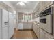 Bright kitchen featuring classic white appliances and plenty of cabinet space at 3537 W Shangri La Rd, Phoenix, AZ 85029
