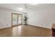 Neutral living room with a ceiling fan, glass patio doors, and tile flooring at 3537 W Shangri La Rd, Phoenix, AZ 85029