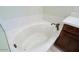 Close up of the bathroom soaking tub with bronze faucet, marbled surround and wood cabinets at 3935 E Rough Rider Rd # 1101, Phoenix, AZ 85050