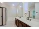 Bathroom features double sinks, framed mirrors, wood cabinets, soaking tub, and separate shower at 3935 E Rough Rider Rd # 1101, Phoenix, AZ 85050