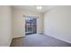 Bright bedroom featuring neutral walls, gray carpet, and a sliding glass door to the outside at 3935 E Rough Rider Rd # 1101, Phoenix, AZ 85050