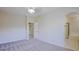 Spacious bedroom featuring neutral carpet, a ceiling fan, ensuite bathroom and walk in closet access at 3935 E Rough Rider Rd # 1101, Phoenix, AZ 85050