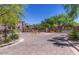 Community entrance with stone signage, mature trees, and wrought iron gates at 3935 E Rough Rider Rd # 1101, Phoenix, AZ 85050