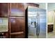 Close-up of the stainless steel refrigerator and dark-stained kitchen cabinets at 3935 E Rough Rider Rd # 1101, Phoenix, AZ 85050