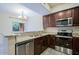 Modern kitchen featuring granite counters, a double sink, and stainless steel appliances at 3935 E Rough Rider Rd # 1101, Phoenix, AZ 85050