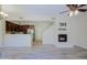 Open-concept living space with modern fireplace and adjacent kitchen at 3935 E Rough Rider Rd # 1101, Phoenix, AZ 85050