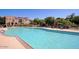 Community pool with lounge chairs, umbrellas, and well-maintained grounds at 3935 E Rough Rider Rd # 1101, Phoenix, AZ 85050