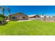 Lush backyard featuring a green lawn, a concrete patio, and a block wall, ideal for outdoor living at 3940 E Heather Ct, Gilbert, AZ 85234