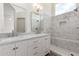 Bright bathroom featuring a marble vanity with double sinks and a glass-enclosed shower with marble tiling at 3940 E Heather Ct, Gilbert, AZ 85234