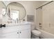Bathroom featuring a modern vanity, round mirror, and a shower-tub combination at 3940 E Heather Ct, Gilbert, AZ 85234