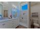 Beautiful bathroom featuring double sinks, a spacious shower with marble surround, and plenty of natural light at 3940 E Heather Ct, Gilbert, AZ 85234