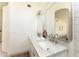 Bright bathroom featuring double sinks with marble counters, contemporary mirrors, and modern lighting at 3940 E Heather Ct, Gilbert, AZ 85234