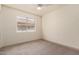 Bright bedroom with neutral carpet, baseboards, and window view of the backyard at 3940 E Heather Ct, Gilbert, AZ 85234