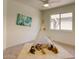 Cozy bedroom with a large window, fan, and a playful teepee with stuffed animals on the carpet at 3940 E Heather Ct, Gilbert, AZ 85234