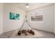 Bright bedroom with a decorative teepee, ceiling fan, and neutral carpet at 3940 E Heather Ct, Gilbert, AZ 85234