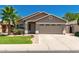 Charming single-story home with desert landscaping, a two-car garage, and a well-maintained lawn at 3940 E Heather Ct, Gilbert, AZ 85234
