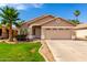 Charming single-story home with a well-manicured lawn, desert landscaping, and a two-car garage at 3940 E Heather Ct, Gilbert, AZ 85234