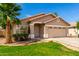 Inviting single-story home with a manicured lawn, desert landscaping, and a convenient two-car garage at 3940 E Heather Ct, Gilbert, AZ 85234