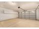 Spacious three car garage with storage cabinets, epoxy floors, and large doors at 3940 E Heather Ct, Gilbert, AZ 85234