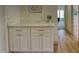 Hallway featuring white cabinets with a quartz countertop, and hardwood floors at 3940 E Heather Ct, Gilbert, AZ 85234