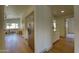 Hallway view with stainless steel refrigerator, white cabinets, and hardwood floors at 3940 E Heather Ct, Gilbert, AZ 85234