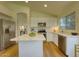 Modern kitchen with white cabinets, stainless steel appliances, and quartz countertops at 3940 E Heather Ct, Gilbert, AZ 85234