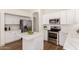 Updated kitchen with white cabinets, stainless steel appliances, and quartz countertops at 3940 E Heather Ct, Gilbert, AZ 85234