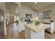 Bright kitchen featuring white cabinets, stainless steel appliances, and an island with a quartz countertop at 3940 E Heather Ct, Gilbert, AZ 85234