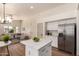 Open-concept kitchen with island, stainless steel appliances, and a clear view to the living room at 3940 E Heather Ct, Gilbert, AZ 85234