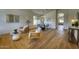 Bright living room featuring hardwood floors, modern furnishings, and large windows at 3940 E Heather Ct, Gilbert, AZ 85234