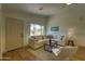 Inviting living room featuring a comfortable sectional sofa and natural light from the backyard window at 3940 E Heather Ct, Gilbert, AZ 85234