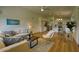 Open-concept living room showcasing hardwood floors and a seamless transition to the adjacent kitchen area at 3940 E Heather Ct, Gilbert, AZ 85234