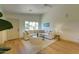 Comfortable living room with a large sectional sofa, hardwood floors, and ample natural light at 3940 E Heather Ct, Gilbert, AZ 85234