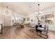 Open-concept living and dining area with modern furnishings, wood floors, and lots of natural light at 3940 E Heather Ct, Gilbert, AZ 85234